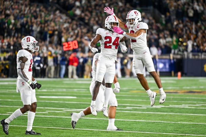 South Bend, Indiana, USA; Stanford Cardinal safety Patrick Fields (24) and safety Jonathan McGill (2) celebrate after a defensive stop in the first quarter against the Notre Dame Fighting Irish at Notre Dame Stadium.
